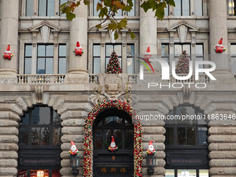 Santa Claus decorations are seen on the exterior wall of Roosevelt Residence on the Bund in Shanghai, China, on December 13, 2024. (