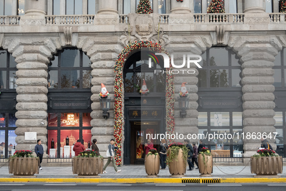 Santa Claus decorations are seen on the exterior wall of Roosevelt Residence on the Bund in Shanghai, China, on December 13, 2024. 