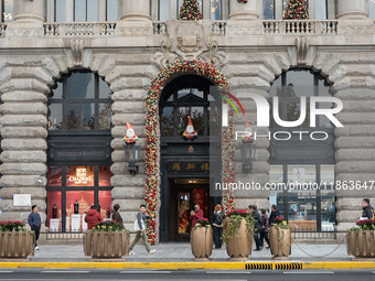 Santa Claus decorations are seen on the exterior wall of Roosevelt Residence on the Bund in Shanghai, China, on December 13, 2024. (