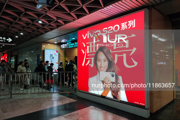 An LED screen displays tennis star Zheng Qinwen's vivo mobile phone advertisement in a subway transfer channel in Shanghai, China, on Decemb...