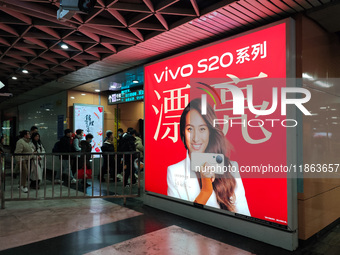 An LED screen displays tennis star Zheng Qinwen's vivo mobile phone advertisement in a subway transfer channel in Shanghai, China, on Decemb...