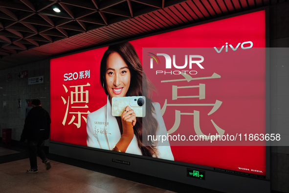 An LED screen displays tennis star Zheng Qinwen's vivo mobile phone advertisement in a subway transfer channel in Shanghai, China, on Decemb...