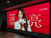 An LED screen displays tennis star Zheng Qinwen's vivo mobile phone advertisement in a subway transfer channel in Shanghai, China, on Decemb...