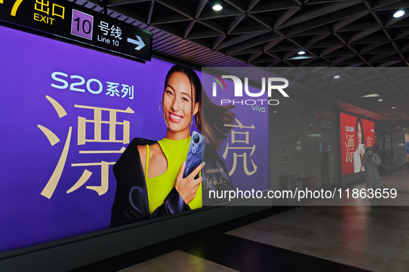 An LED screen displays tennis star Zheng Qinwen's vivo mobile phone advertisement in a subway transfer channel in Shanghai, China, on Decemb...