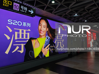 An LED screen displays tennis star Zheng Qinwen's vivo mobile phone advertisement in a subway transfer channel in Shanghai, China, on Decemb...