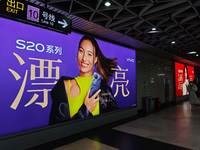 An LED screen displays tennis star Zheng Qinwen's vivo mobile phone advertisement in a subway transfer channel in Shanghai, China, on Decemb...