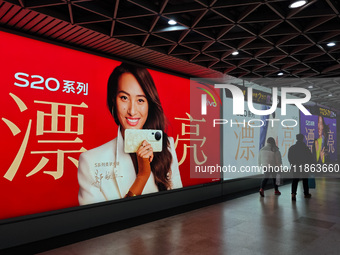 An LED screen displays tennis star Zheng Qinwen's vivo mobile phone advertisement in a subway transfer channel in Shanghai, China, on Decemb...