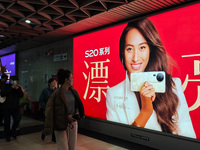 An LED screen displays tennis star Zheng Qinwen's vivo mobile phone advertisement in a subway transfer channel in Shanghai, China, on Decemb...