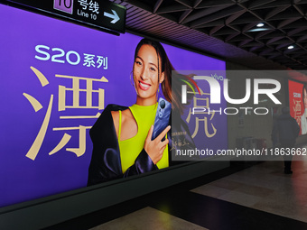 An LED screen displays tennis star Zheng Qinwen's vivo mobile phone advertisement in a subway transfer channel in Shanghai, China, on Decemb...