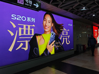 An LED screen displays tennis star Zheng Qinwen's vivo mobile phone advertisement in a subway transfer channel in Shanghai, China, on Decemb...