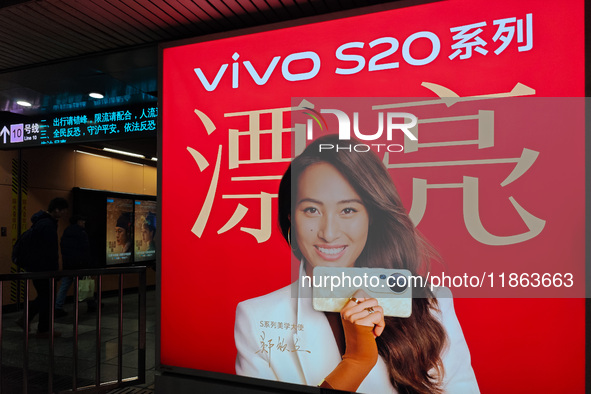 An LED screen displays tennis star Zheng Qinwen's vivo mobile phone advertisement in a subway transfer channel in Shanghai, China, on Decemb...