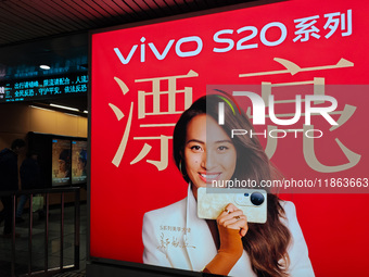 An LED screen displays tennis star Zheng Qinwen's vivo mobile phone advertisement in a subway transfer channel in Shanghai, China, on Decemb...