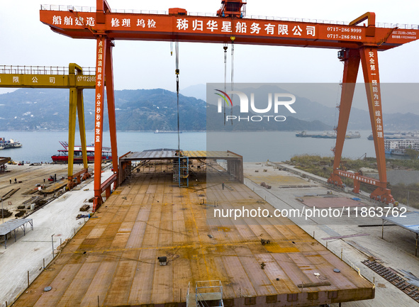 Workers build a new energy vehicle ro-ro ship at the Huaxing Ship Construction base in Zigui County, Yichang City, Hubei province, China, on...