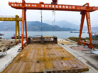 Workers build a new energy vehicle ro-ro ship at the Huaxing Ship Construction base in Zigui County, Yichang City, Hubei province, China, on...