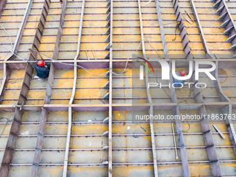 Workers build a new energy vehicle ro-ro ship at the Huaxing Ship Construction base in Zigui County, Yichang City, Hubei province, China, on...