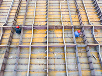 Workers build a new energy vehicle ro-ro ship at the Huaxing Ship Construction base in Zigui County, Yichang City, Hubei province, China, on...