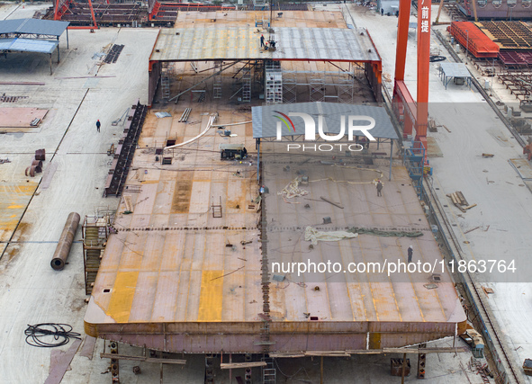 Workers build a new energy vehicle ro-ro ship at the Huaxing Ship Construction base in Zigui County, Yichang City, Hubei province, China, on...