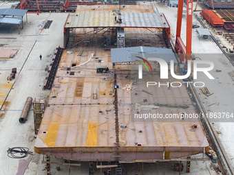 Workers build a new energy vehicle ro-ro ship at the Huaxing Ship Construction base in Zigui County, Yichang City, Hubei province, China, on...