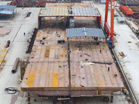 Workers build a new energy vehicle ro-ro ship at the Huaxing Ship Construction base in Zigui County, Yichang City, Hubei province, China, on...