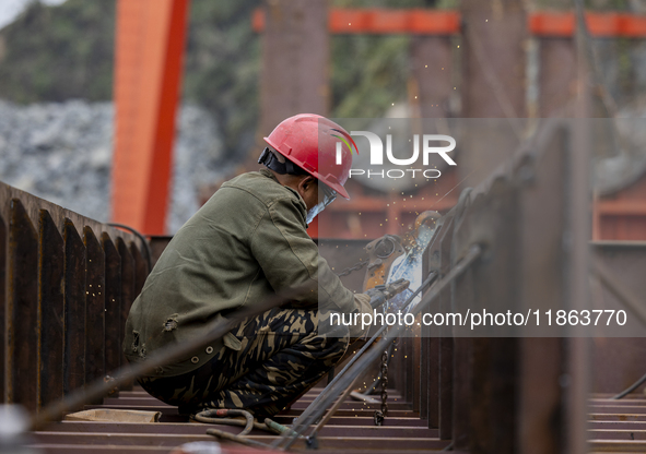 Workers build a new energy vehicle ro-ro ship at the Huaxing Ship Construction base in Zigui County, Yichang City, Hubei province, China, on...