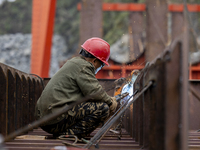 Workers build a new energy vehicle ro-ro ship at the Huaxing Ship Construction base in Zigui County, Yichang City, Hubei province, China, on...