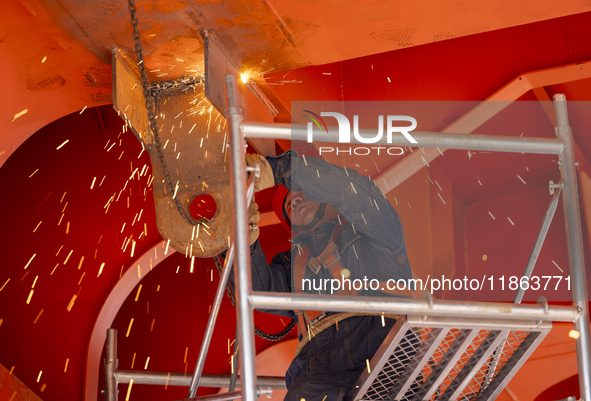 Workers build a new energy vehicle ro-ro ship at the Huaxing Ship Construction base in Zigui County, Yichang City, Hubei province, China, on...