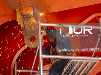 Workers build a new energy vehicle ro-ro ship at the Huaxing Ship Construction base in Zigui County, Yichang City, Hubei province, China, on...