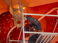 Workers build a new energy vehicle ro-ro ship at the Huaxing Ship Construction base in Zigui County, Yichang City, Hubei province, China, on...