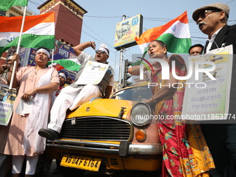 Supporters of the Indian National Congress take part in a protest against the Calcutta High Court's 2008 order that no commercial vehicle ol...