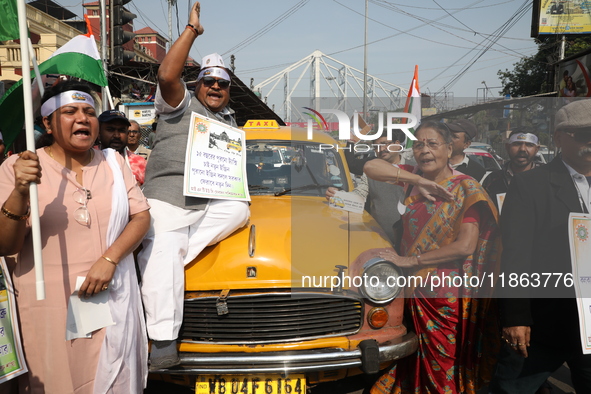 Supporters of the Indian National Congress take part in a protest against the Calcutta High Court's 2008 order that no commercial vehicle ol...