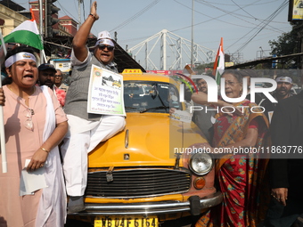 Supporters of the Indian National Congress take part in a protest against the Calcutta High Court's 2008 order that no commercial vehicle ol...