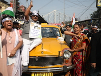 Supporters of the Indian National Congress take part in a protest against the Calcutta High Court's 2008 order that no commercial vehicle ol...