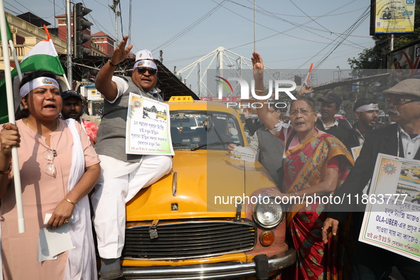 Supporters of the Indian National Congress take part in a protest against the Calcutta High Court's 2008 order that no commercial vehicle ol...