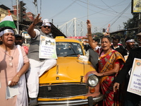 Supporters of the Indian National Congress take part in a protest against the Calcutta High Court's 2008 order that no commercial vehicle ol...