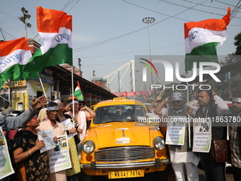 Supporters of the Indian National Congress take part in a protest against the Calcutta High Court's 2008 order that no commercial vehicle ol...