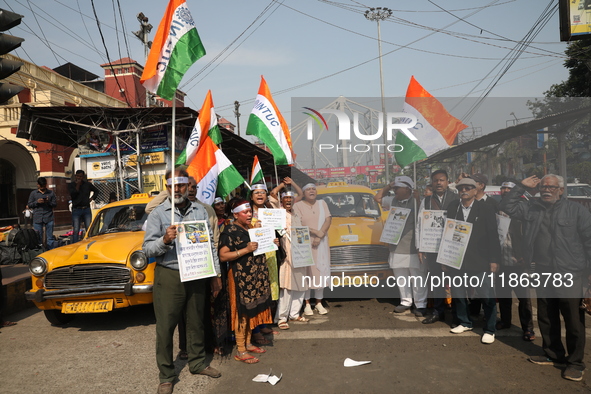 Supporters of the Indian National Congress take part in a protest against the Calcutta High Court's 2008 order that no commercial vehicle ol...