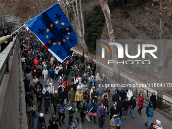 Private sector workers, students, and protesters take to the streets for a demonstration against the Georgian government's postponement of E...