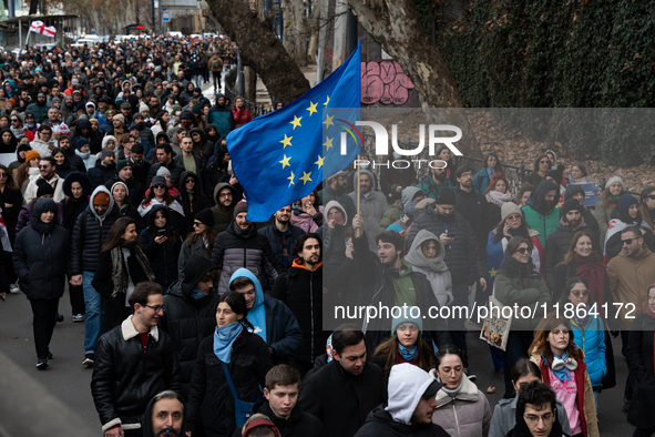 Private sector workers, students, and protesters take to the streets for a demonstration against the Georgian government's postponement of E...