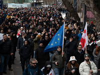 Private sector workers, students, and protesters take to the streets for a demonstration against the Georgian government's postponement of E...