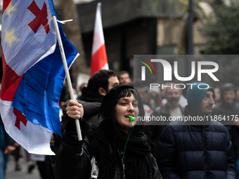 Private sector workers, students, and protesters take to the streets for a demonstration against the Georgian government's postponement of E...