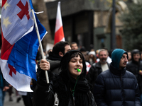 Private sector workers, students, and protesters take to the streets for a demonstration against the Georgian government's postponement of E...