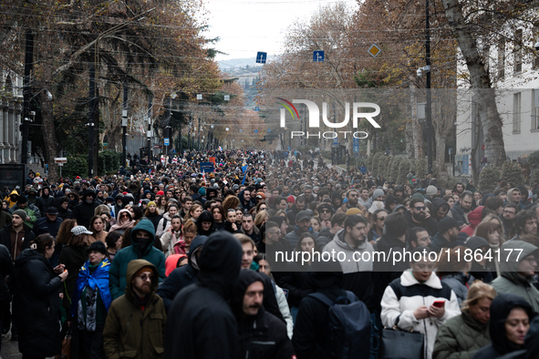 Private sector workers, students, and protesters take to the streets for a demonstration against the Georgian government's postponement of E...