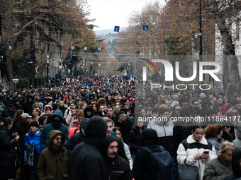 Private sector workers, students, and protesters take to the streets for a demonstration against the Georgian government's postponement of E...