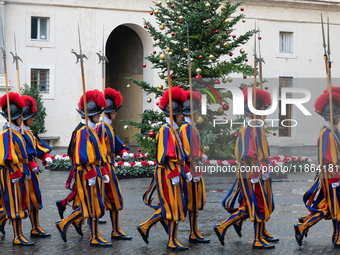 A group of the Swiss Guard walks across the San Damaso courtyard during the arrival of Lebanon's Prime Minister Najib Mikati in Vatican City...