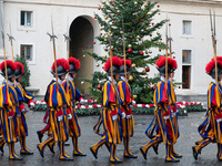 A group of the Swiss Guard walks across the San Damaso courtyard during the arrival of Lebanon's Prime Minister Najib Mikati in Vatican City...