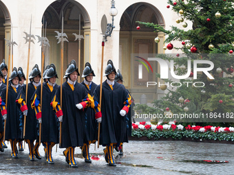 A group of the Swiss Guard walks across the San Damaso courtyard during the arrival of Lebanon's Prime Minister Najib Mikati in Vatican City...