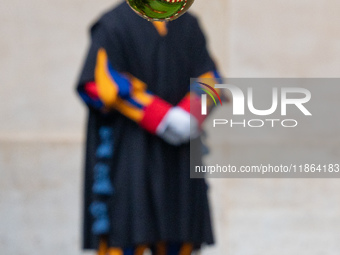 A member of the Swiss Guard walks across the San Damaso courtyard during the arrival of Lebanon's Prime Minister Najib Mikati in Vatican Cit...