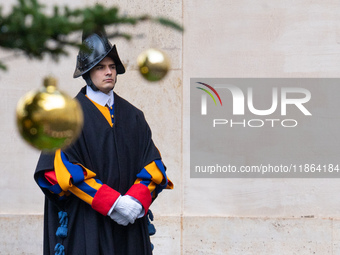 A member of the Swiss Guard walks across the San Damaso courtyard during the arrival of Lebanon's Prime Minister Najib Mikati in Vatican Cit...