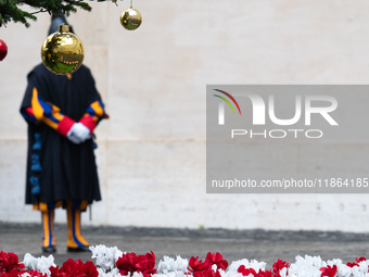 A member of the Swiss Guard walks across the San Damaso courtyard during the arrival of Lebanon's Prime Minister Najib Mikati in Vatican Cit...