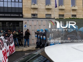 During a student march, a clash occurs in front of the Polytechnic University in Turin, Italy, on December 13, 2024. The students attempt to...